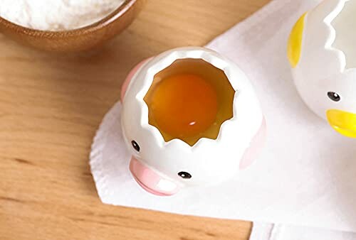 A ceramic egg separator with egg yolk inside