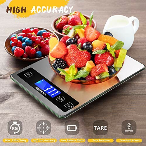 Digital kitchen scale with a bowl of mixed fruit on top.